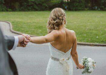 Bride and groom holding hands (Unsplash | Tom The Photographer)