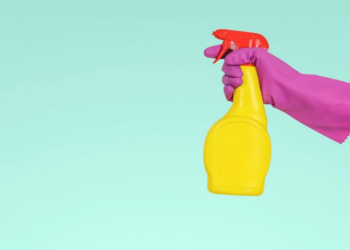 Image of hand spraying cleaning product (Unsplash)