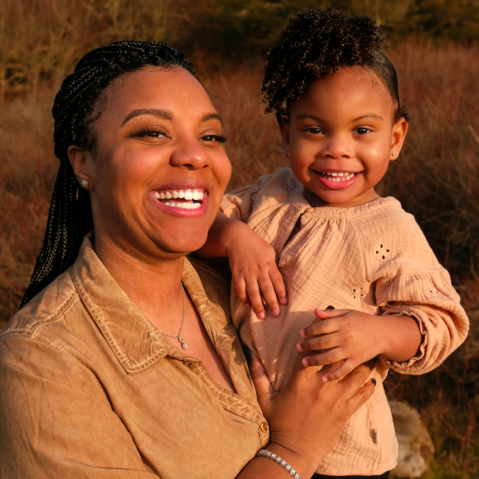 Mom and daughter smiling