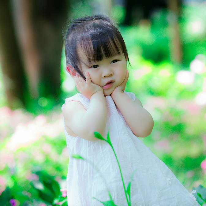 Little girl outdoors in white dress