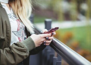 woman holding red phone