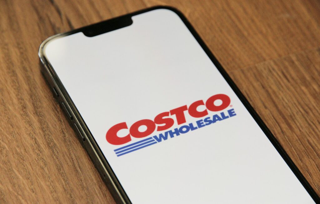 a close up of a cell phone on a table displaying the Costco app