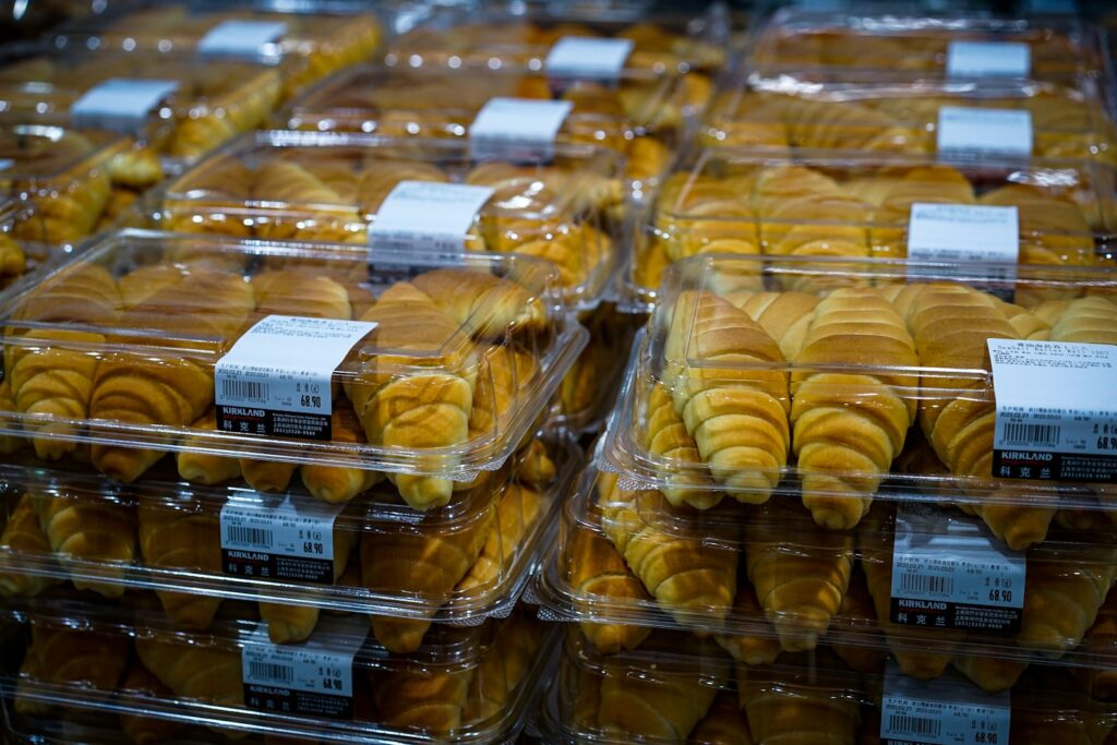 a close up of many pastries in plastic containers at Costco
