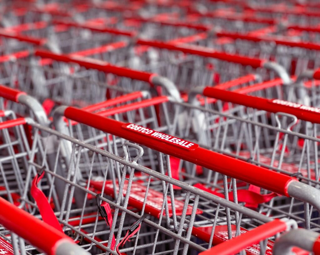 a row of red and silver shopping carts at Costco