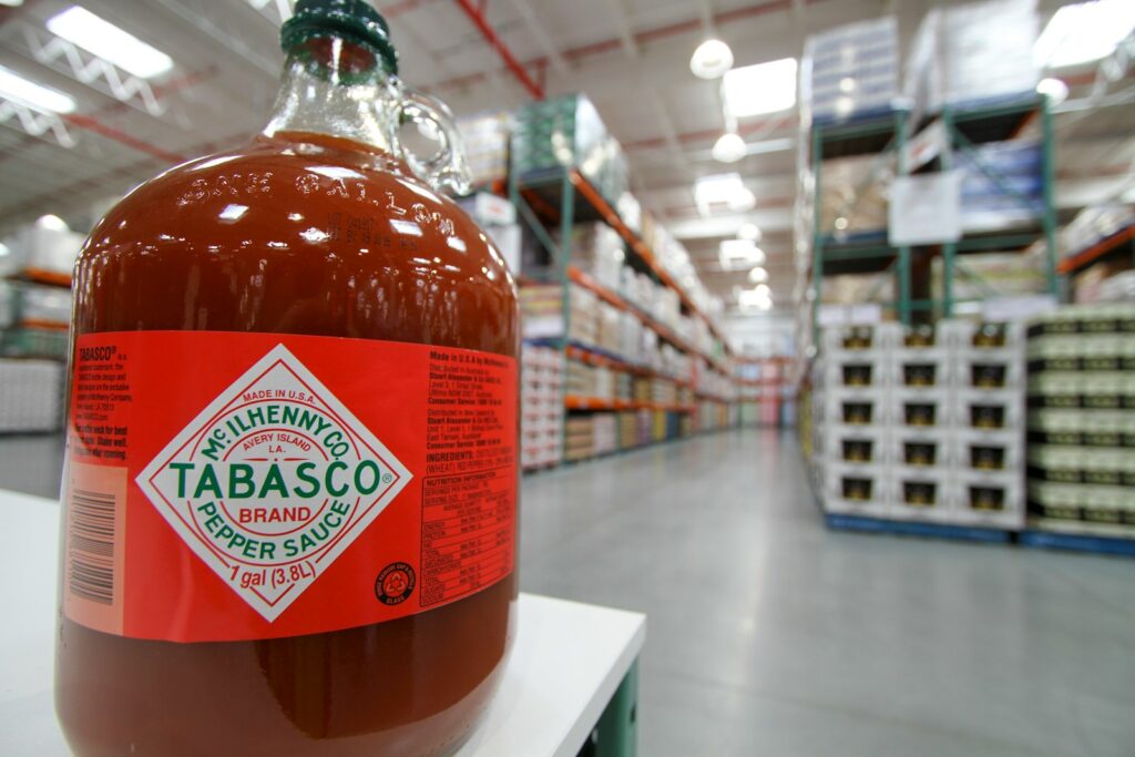 a bottle of tabasco sitting on a shelf in a Costco.