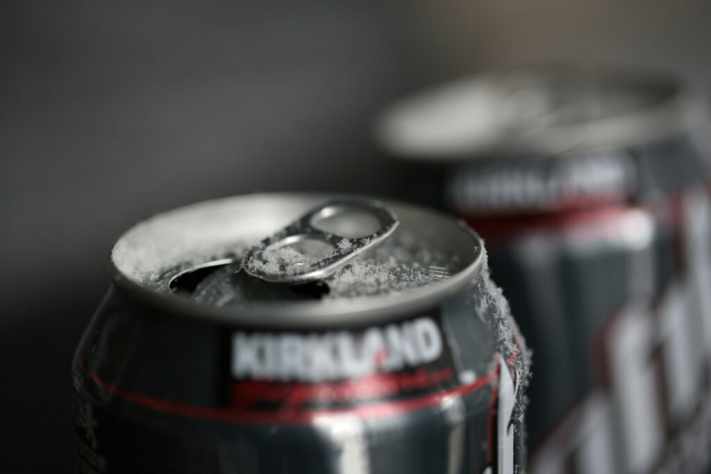 Kirkland brand soda cans in front of a gray background