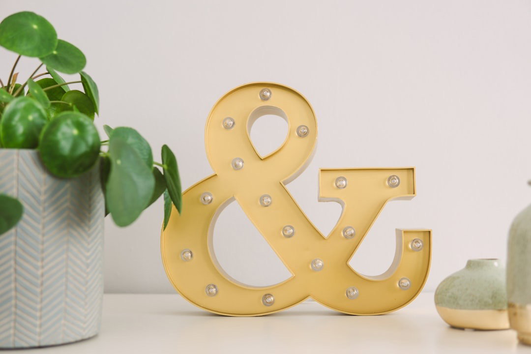 An ampersand marquee sign propped up on a table.