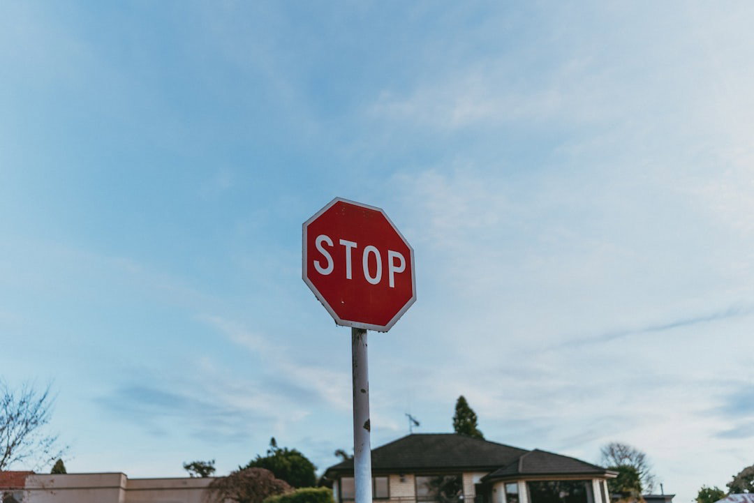An image of a stop sign against a blue sky.