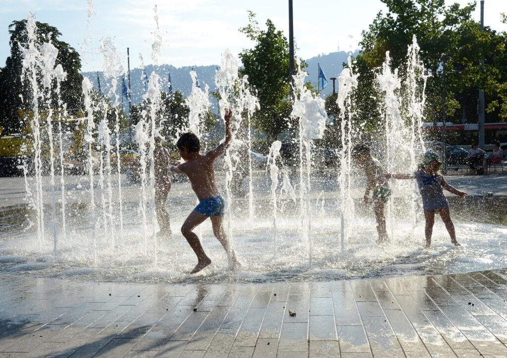 children playing, water fountain, zurich