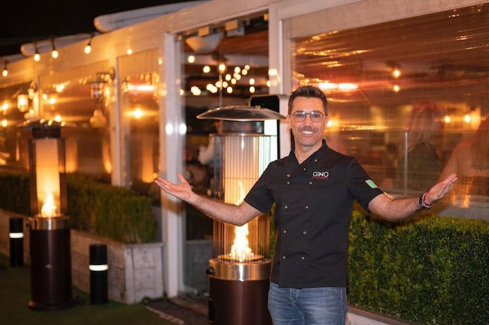 Gino D'Acampo in front of restaurant