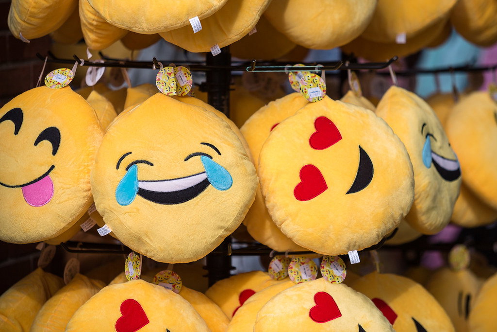 a bunch of emoji plushie toys