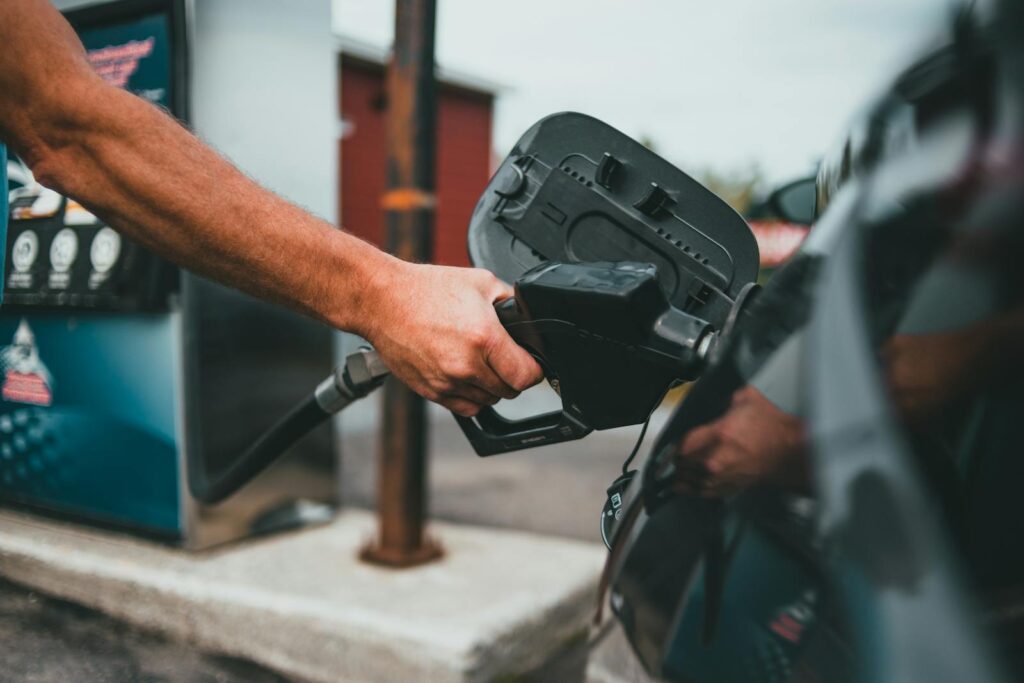 Person Putting Gasoline on a Vehicle