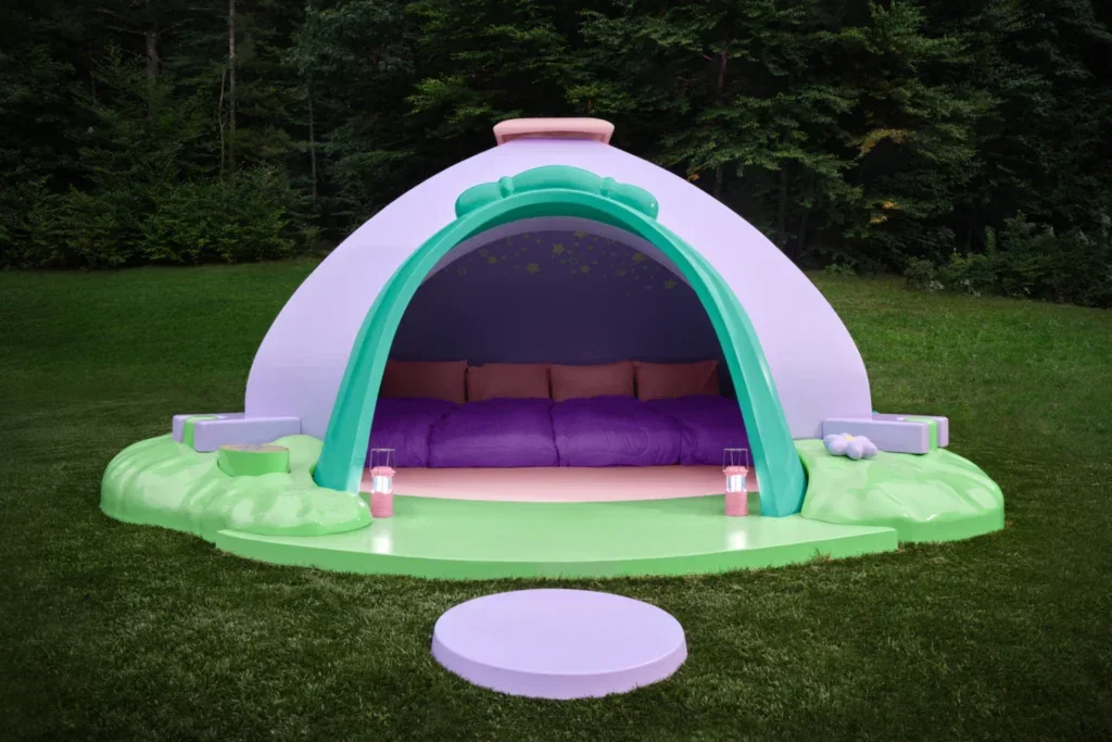 A domed tent covering 4 purple and pink sleeping bags.