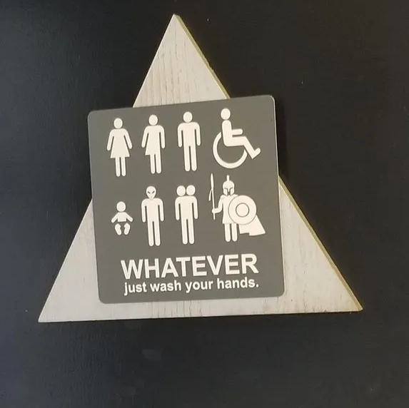 a bathroom sign with stick figures of various genders and alien races