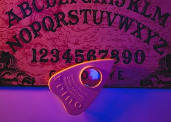 a purple lit room with a sign and a pair of scissors