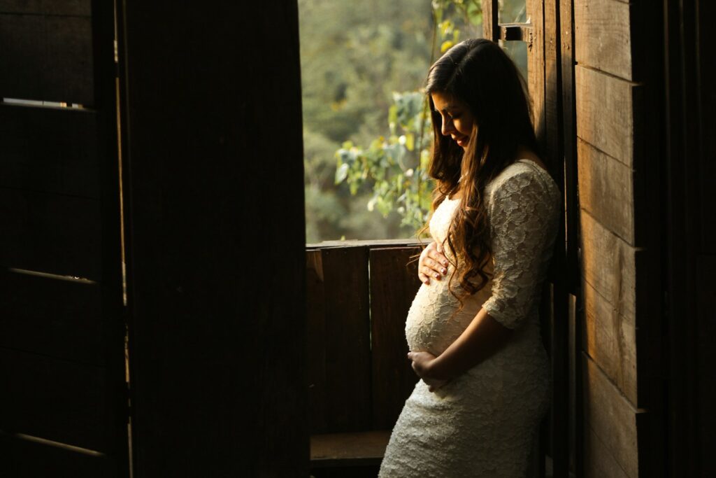 pregnant woman holding her belly
