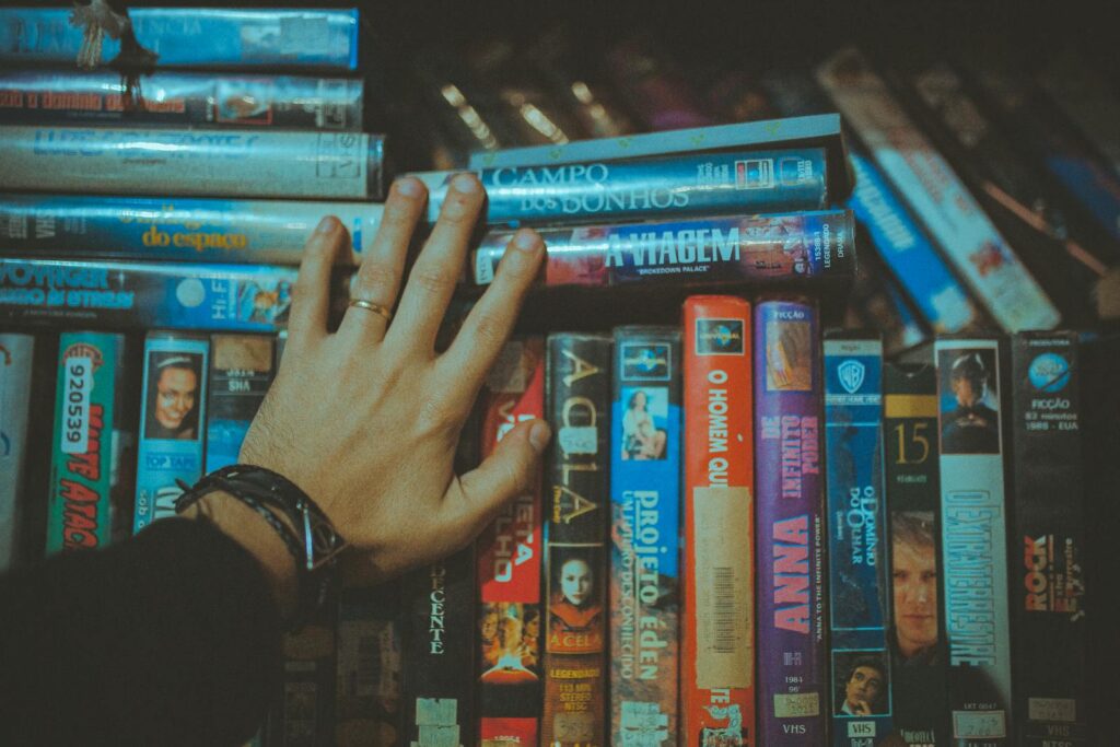 picture of a hand next to a bunch of DVDs