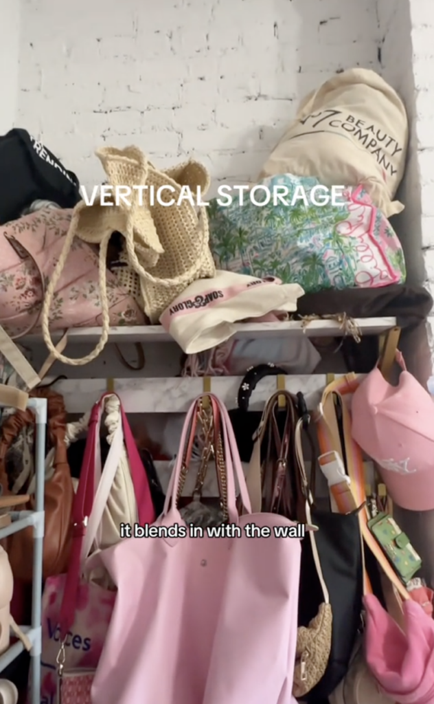 A vertical storage packed with bags, hats and other items.