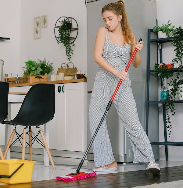 woman dancing and mopping the house