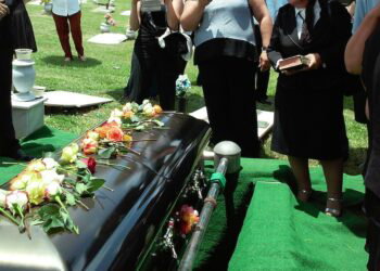 people in front of a coffin