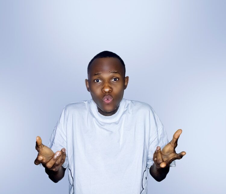 a young boy holding his hands up