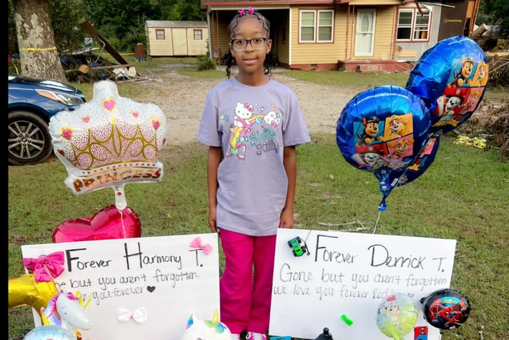 Cassidy Taylor sitting in front of memorials for her two siblings