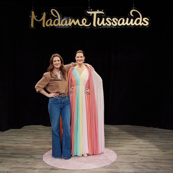 Drew Barrymore posing with her wax figure