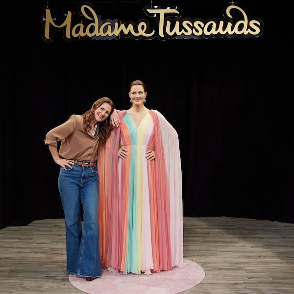 Drew Barrymore posing with her wax figure