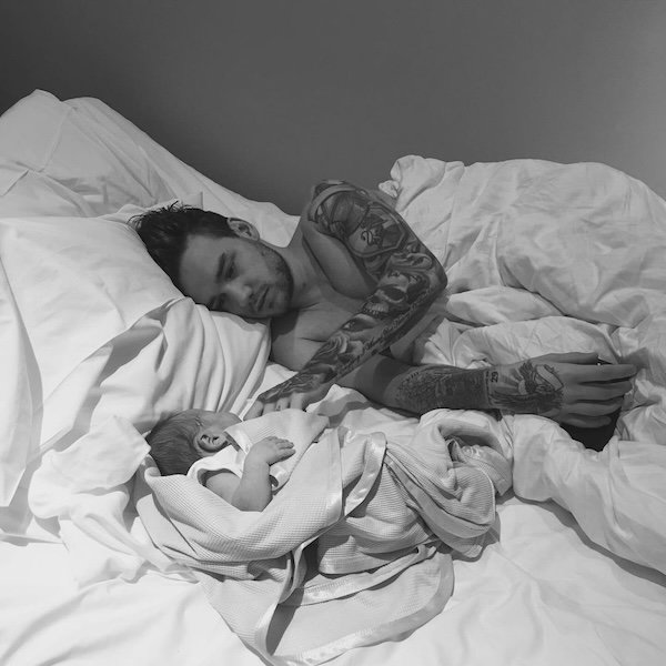 Liam Payne and his son Bear lying together in bed