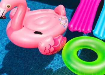 pink inflatable flamingo and green inflatable ring