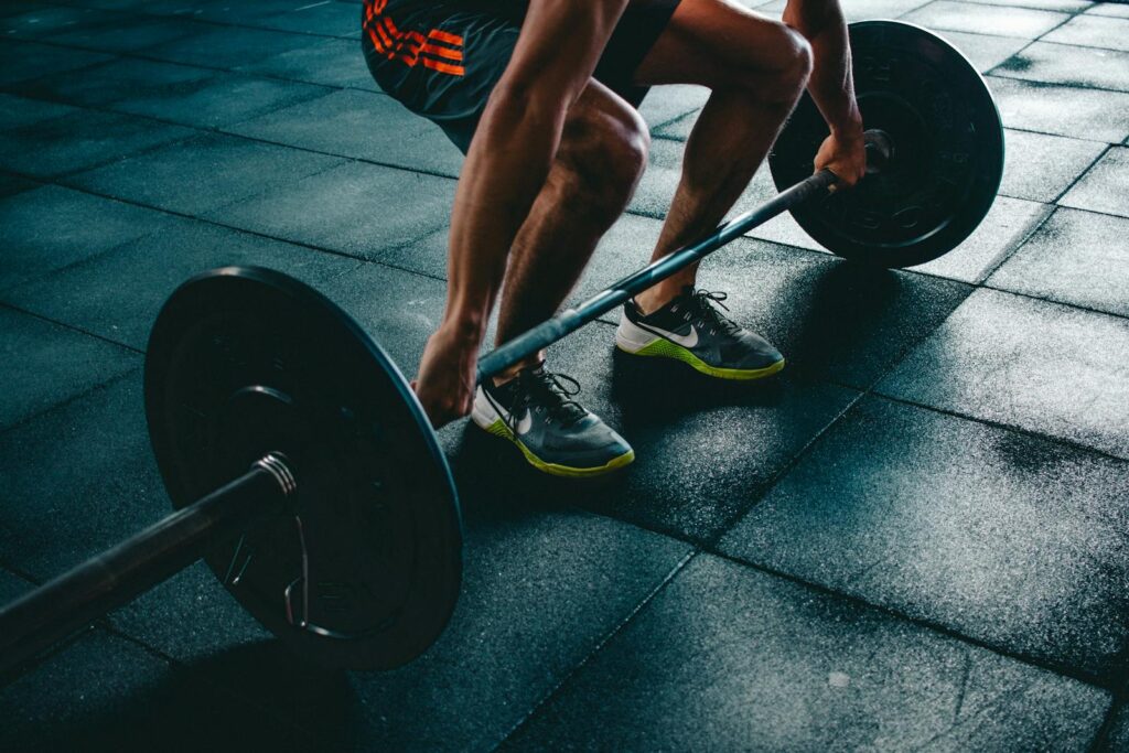 Person Holding Barbell in the gym