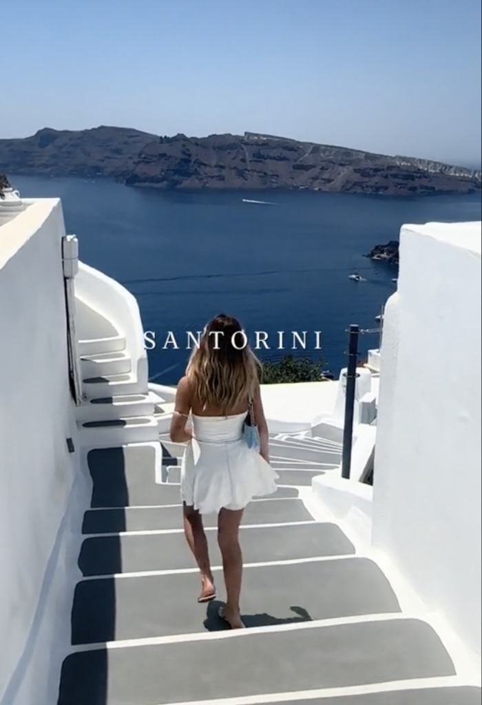 woman in white dress walking down stairs