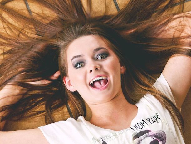 woman lying down and laughing akwardly