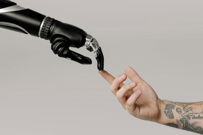 artificial hand holding human hand