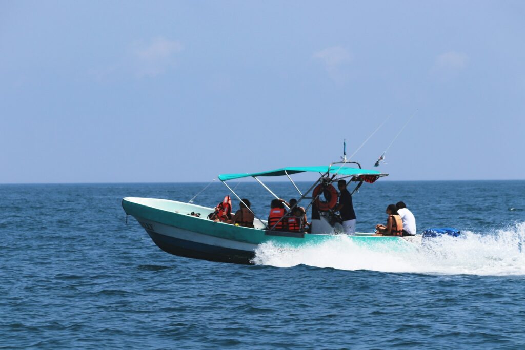 a group of people riding on the back of a boat