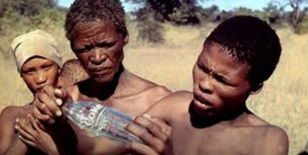 Actor N!xau Toma and others with the Coke bottle in The Gods Must Be Crazy