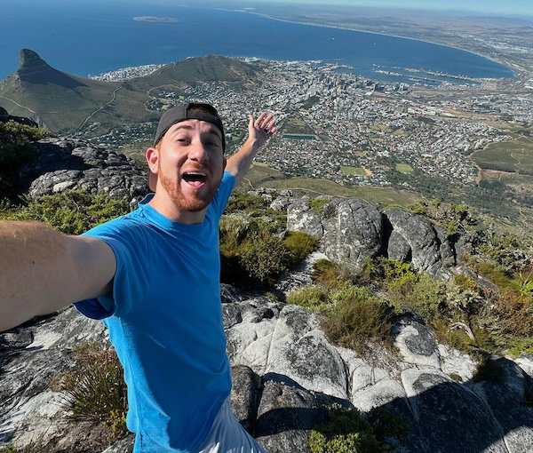 Drew Binsky taking a selfie on a mountain top