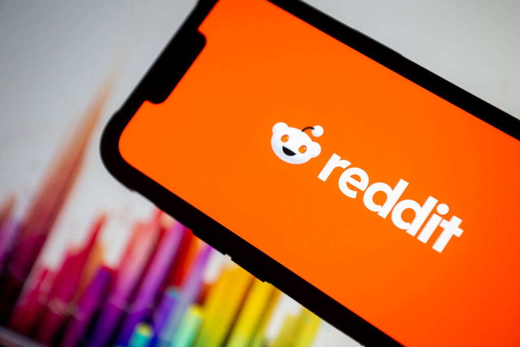 In this photo illustration, the Reddit logo seen displayed...