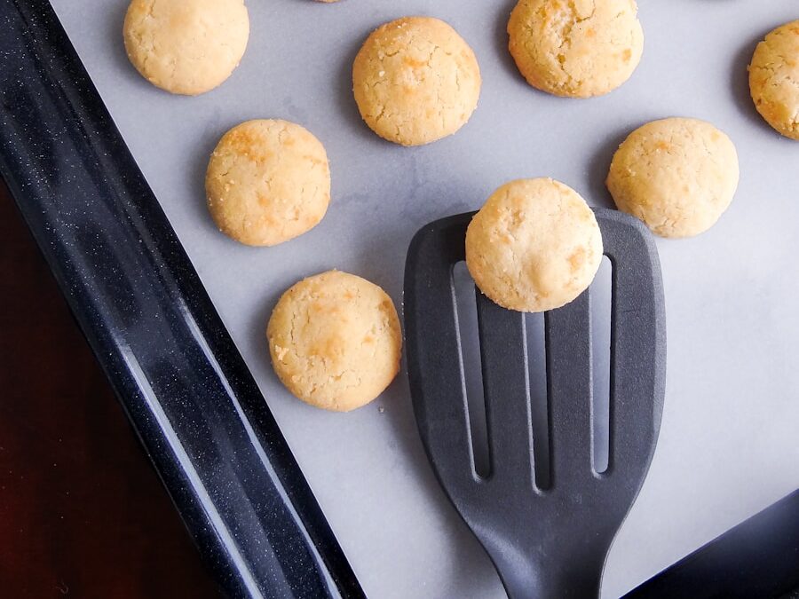 A pan filled with cookies and a spatula
