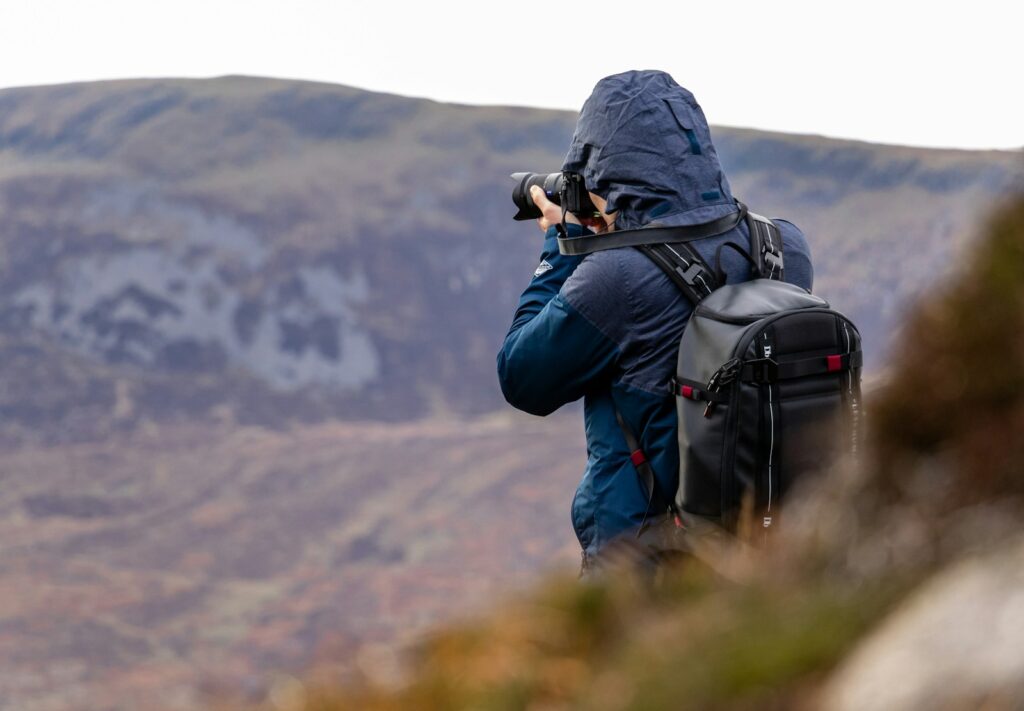 man taking photo of mountain