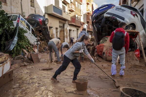 Residents clear mud from the streets in flood-hit Paiporta, Valencia, Spain.