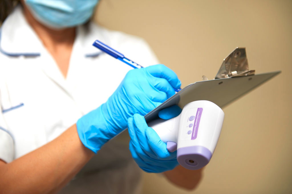 Frontline worker, checking for Covid-19,  taking medical history of patientcovid-19 test
