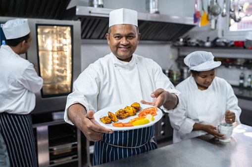 Chef presenting a plate of food