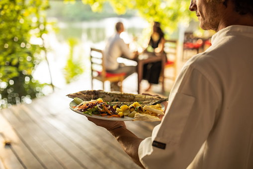 Waiter carrying seafood