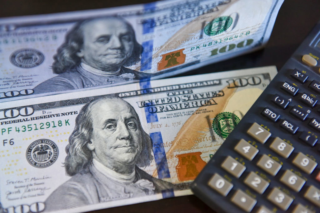 In this photo illustration, several $100 bills are displayed...