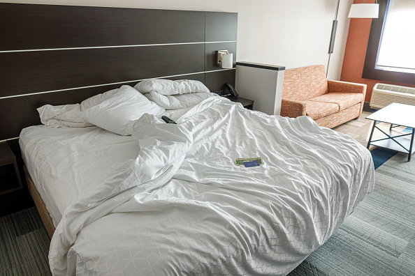 Sanford, Florida, Holiday Inn Express & Suites Sanford, guest room with unmade bed and housekeeping tip