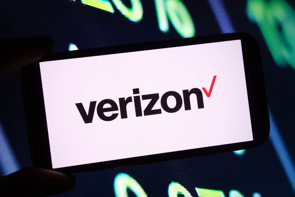In this photo illustration, the Verizon company logo is seen...