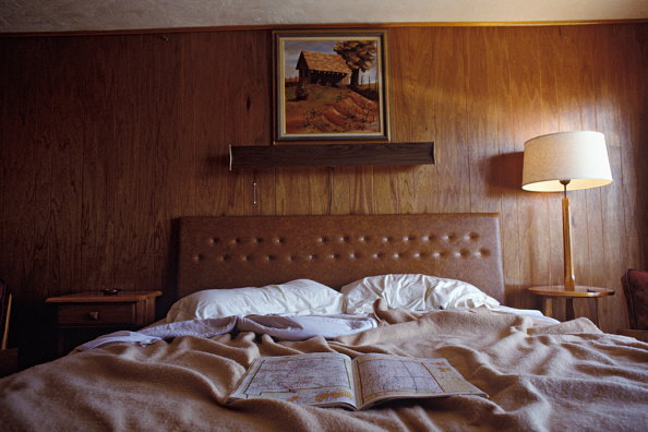 Road Atlas Open on Motel Bed