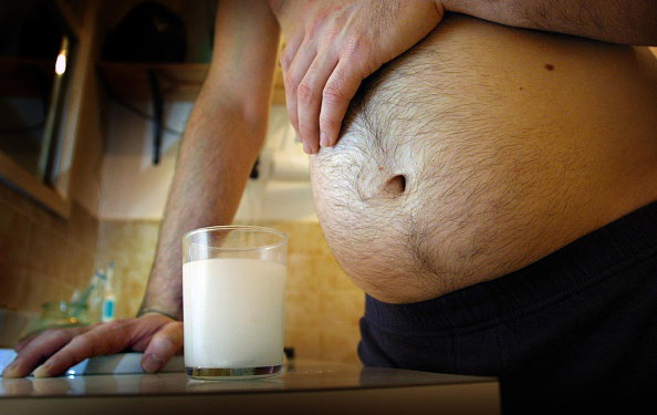 Generic image of man's stomach with a glass of milk, 8 August 2002. The AGE Pi
