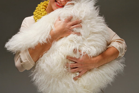 LOS ANGELES, CA - DECEMBER 05, 2012 - Model hugging a White Mongolian lamb fur pillow from Crate & B